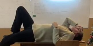 Profesor de la un colegiu național filmat în timp ce stătea tolănit pe catedră în timpul orei profesor întins pe catedră